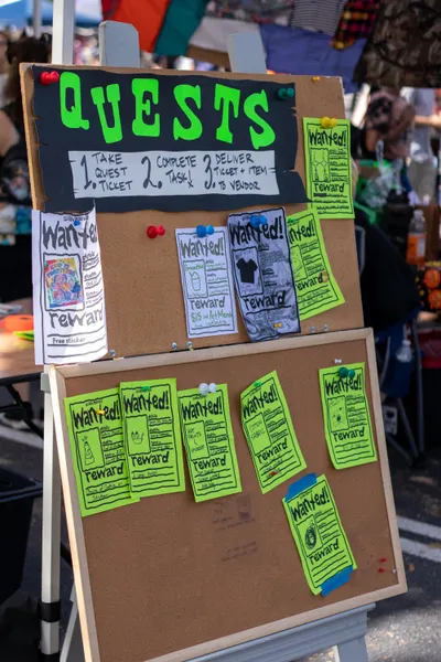 A photo of Goblin Market's quest board with several "WANTED" posters pinned to it.