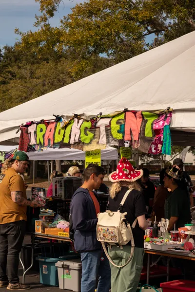 A photo of Goblin Market's trading tent. A quilted banner that says "TRADING TENT" is hung across the top.